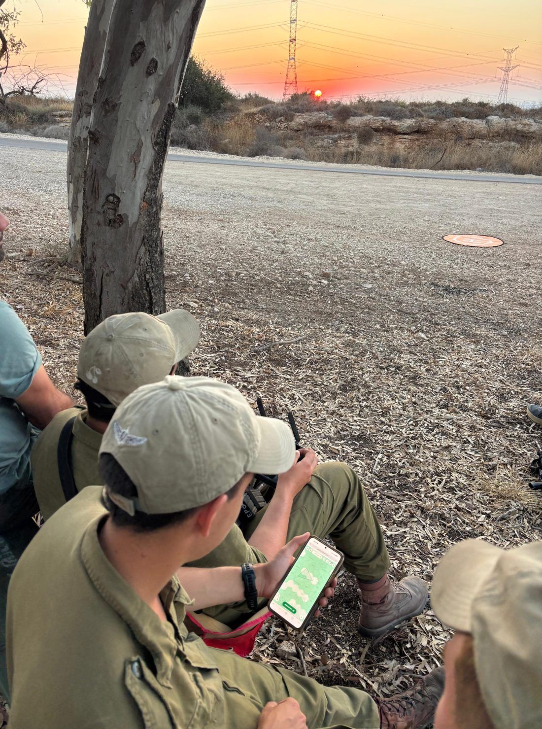 Operators checking the BOND map on a phone in the field before a flight
