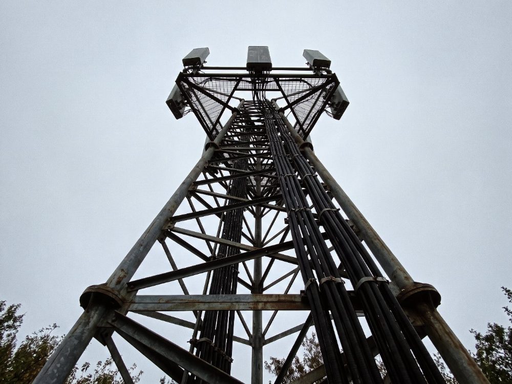 A cellular base station tower seen from below